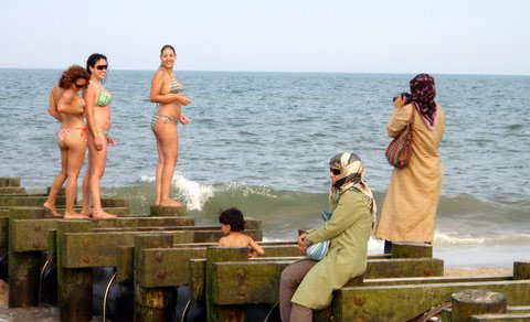 muslim woman takes pic of mermaids
